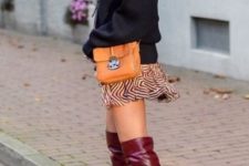 With printed mini skirt, orange bag and black sweater