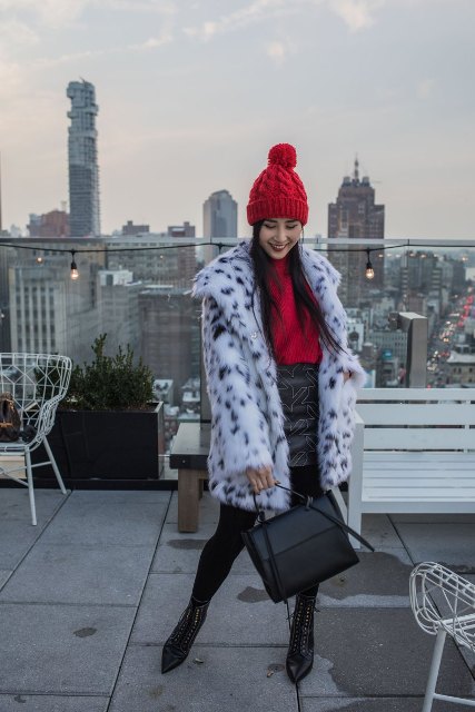With red hat, red sweater, embellished skirt, black bag and printed faux fur coat