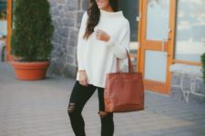 With white loose sweater, brown tote bag and distressed pants