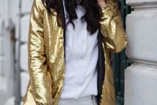 With white shirt, white pants and golden clutch
