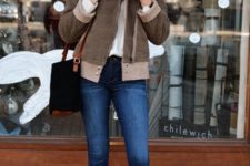 With white turtleneck, fur jacket, skinny jeans and black and brown bag
