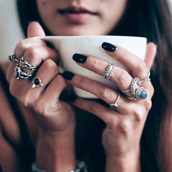 a boho setup of silver rings with various complementing shapes and large rhinestones