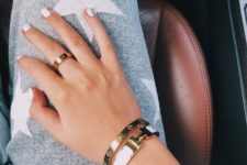 a combo of stylish firm gold bracelets with a white leather touch is super chic and modern