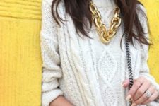 a gold chunky chain necklace looks very matching with a patterned white sweater, perfect for winter
