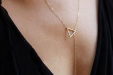 a gorgeous lariat necklace with a triangle and a white pearl comprises geometry and pearl trends in one