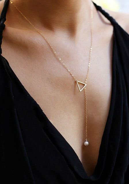 a gorgeous lariat necklace with a triangle and a white pearl comprises geometry and pearl trends in one