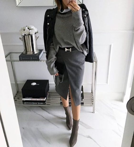 a grey oversized sweater, a graphite grey wrap pencil skirt, sock boots and a black leather jacket