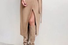 a grey oversized top, a tan wrap midi skirt and matching suede boots for a luxurious minimal look