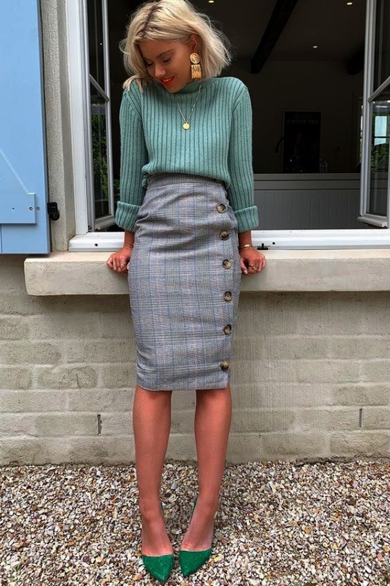 a light green turtleneck, a grey tweed wrap skirt with buttons, apple green suede shoes