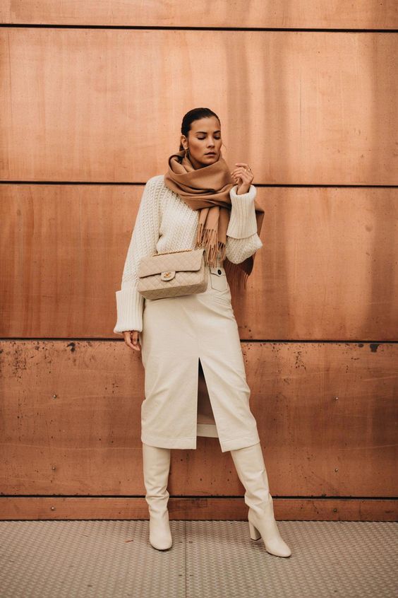 a neutral winter look with an oversized chunky sweater, a white leather pencil skirt, matching boots, a tan bag and a rust-colored scarf