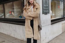 a tan teddy coat, a white tee, black jeans with a raw hem and white booties plus a brown bag