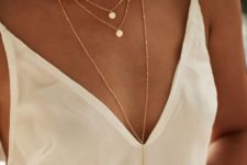 a trio of matching gold necklaces with small coin pendants including a plunging necklace for a truly boho look