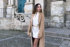 a white sweater mini dress, white knee boots, a tan coat for a minimal winter outfit