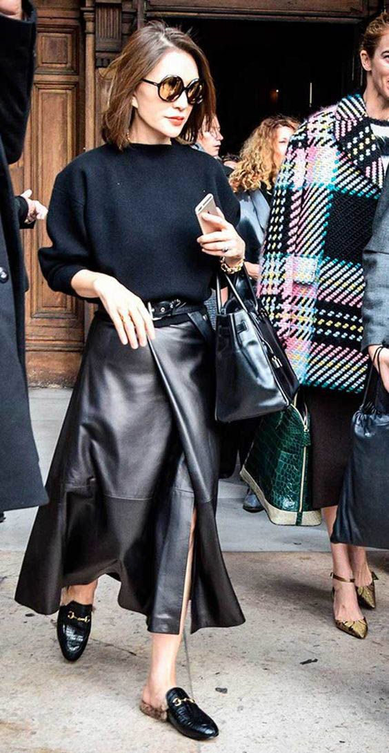 an oversized midnight bleu sweater, a black wrap leather midi skirt, black fur loafers and a black bag