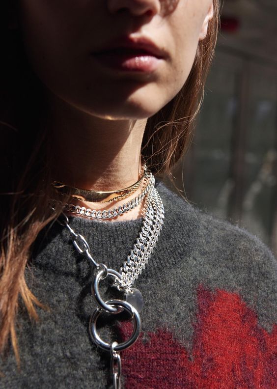 bring the drama with a gold shiny choker and a silver chunky and usual chain lariat necklace