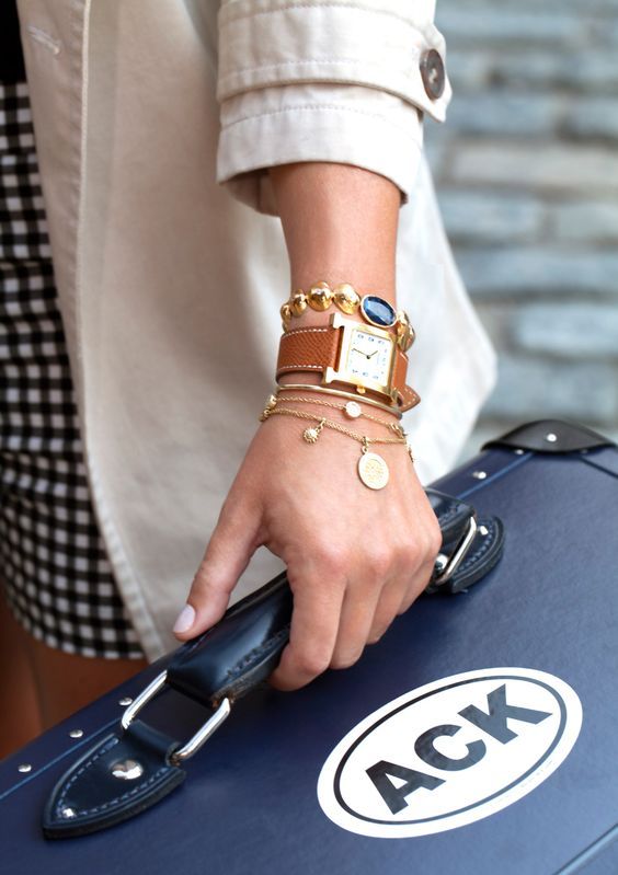 chic stacked bracelets - dainty gold chains with coins, a coin one with a bead and a watch with a brow strap