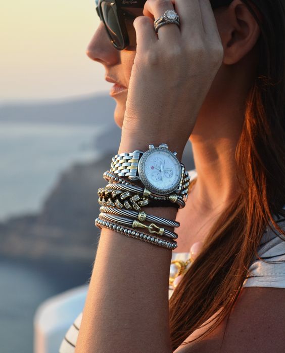 stacked bracelet with beads and texture in the same style plus a watch with a silver finish for a bold look