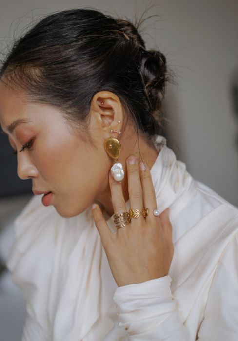 statement gold and baroque pearl earrings plus matching gold and pearl rings for an ultimate modern look