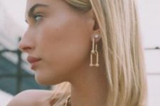 two chunky gold chain necklaces with a large bead pendant and matching earrings worn by Hailey Baldwin