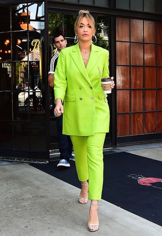 Rita Ora rocking a neon green pantsuit with an oversized blazer and silver shoes looks wow