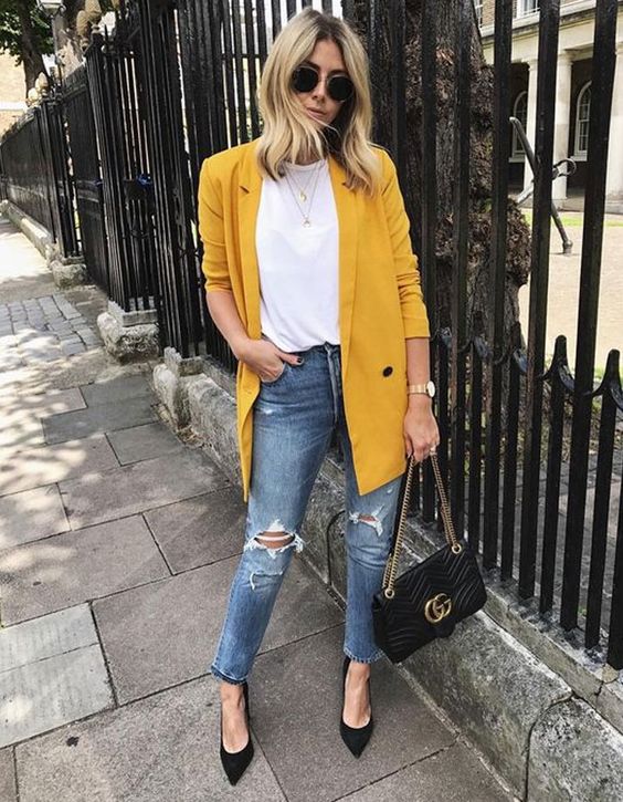 a casual look with a white tee, blue ripped denim, an oversized marigold blazer and black shoes