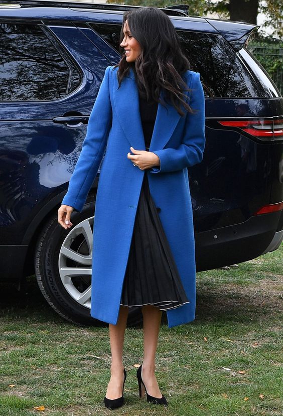 Meghan Markle wearing a classic blue coat to add a trendy feel to her stylish and chic look