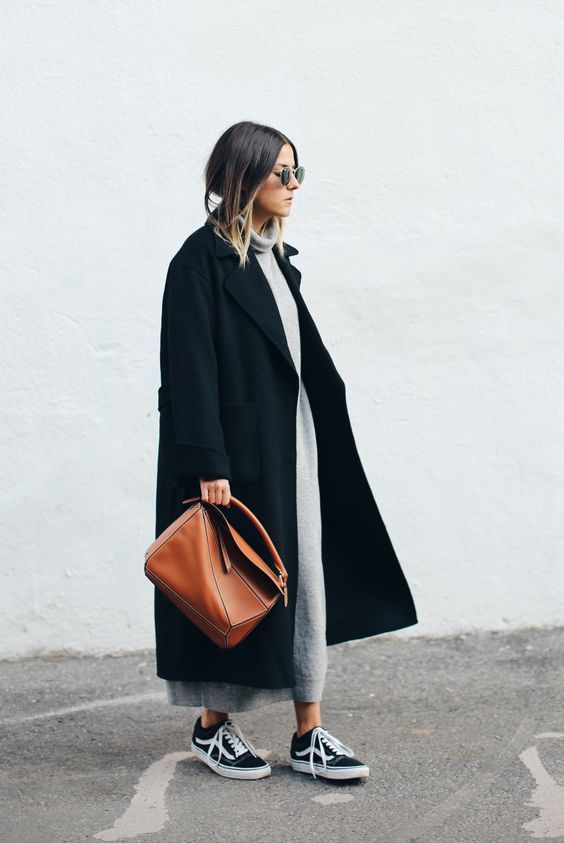 a grey sweater, joggers, black trainers, a black coat and a cognac bag for a chic fall or winter look