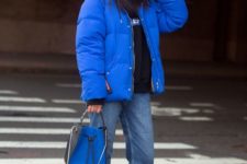 14 a classic blue puff coat and a bag with hint of this color are cool touches to the look this winter