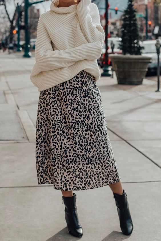 an oversized sweater is paired with a printed midi skirt that shows off the silhouette