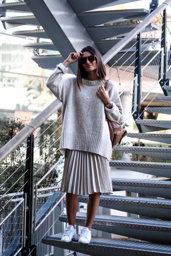 an oversized neutral sweater paired with a matching pleated midi plus sneakers are a cool idea to go for