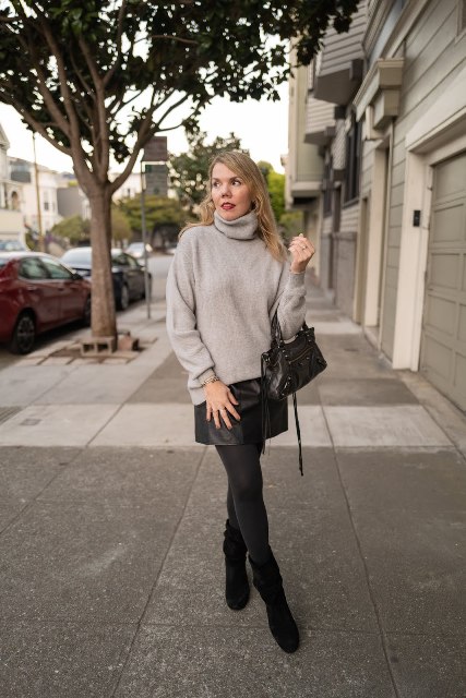 With beige sweater, black leather mini skirt and mini bag