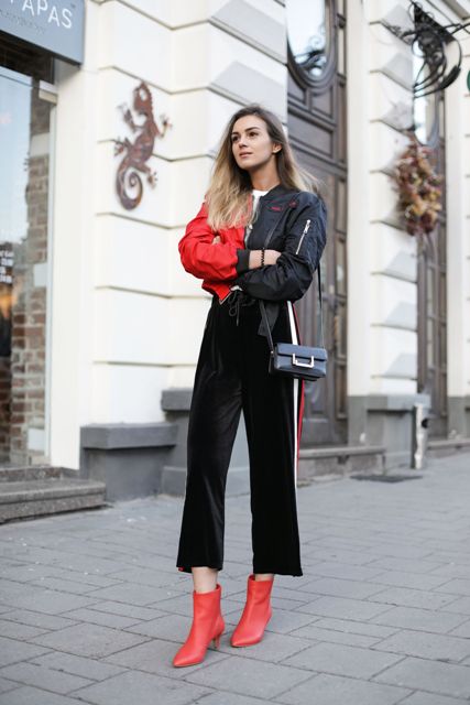 With black and red jacket, mini bag and red ankle boots