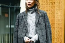 With turtleneck sweater and tweed mini skirt