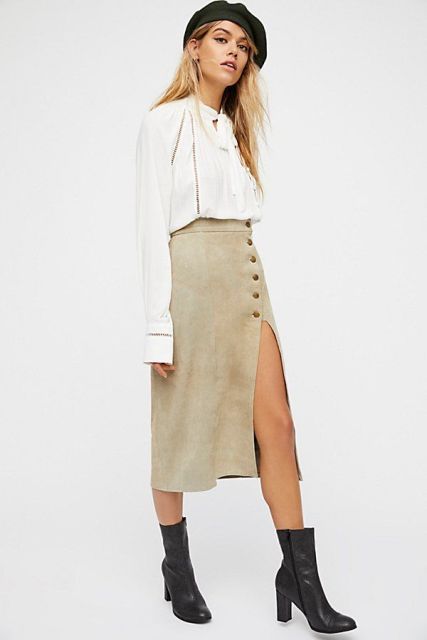 With white ruffled blouse, black ankle boots and beret