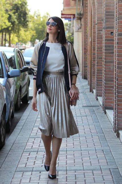 With white shirt, bomber jacket, beige bag and black pumps