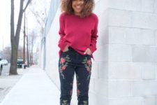 a bright outfit with a fuchsia long sleeve top, black embroidered jeans and black ankle strap shoes