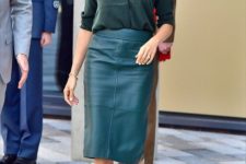 a dark green shirt, a teal leather midi pencil skirt and blush shoes for a bold and statement look