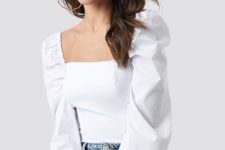 a stylish and romantic look with light blue hig waist jeans and a white puff sleeves blouse with a square neckline