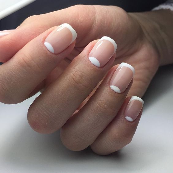 a classic French manicure completed with half moons that compose a double tip look