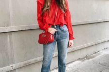 11 a red striped blouse with ruffles, blue straight cropped jeans, white sock booties and a red bag