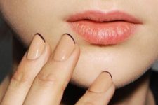 14 beige nails with black micro tips are a fresh take on a French manicure, both with their shape and colors