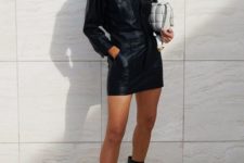 Rosie Huntington Whiteley looking hot in a black leather mini dress, square toe booties and with a white woven leather bag