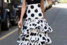 With black top, golden clutch and polka dot shoes