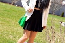 With black top, white blazer, cutout shoes and green bag