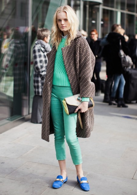 With green sweater, printed coat, green cropped pants and clutch