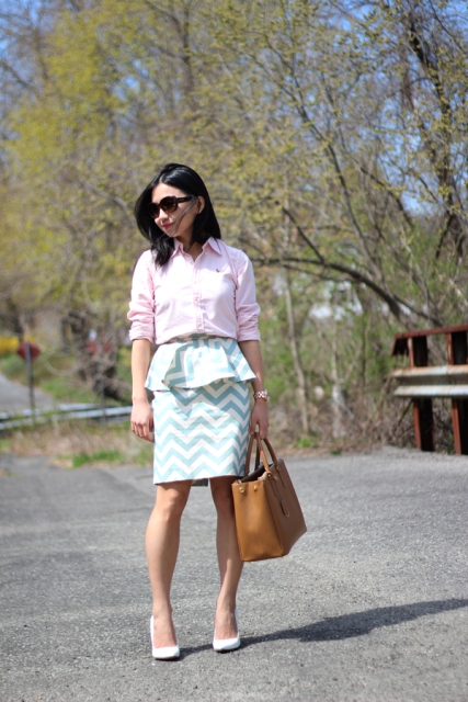 With pale pink button down shirt, brown tote bag and white pumps