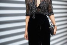With polka dot blouse and black leather clutch