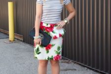 With striped shirt, black embellished clutch and red ankle strap shoes