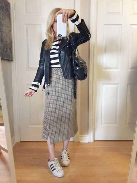 With striped shirt, black leather jacket, black and white sneakers and black leather bag