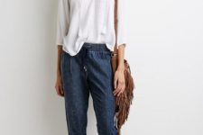 With white loose shirt, brown fringe bag and flat sandals